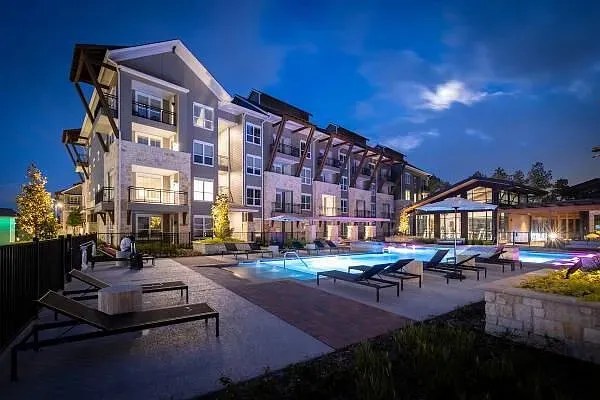 Modern apartment community with pool at dusk